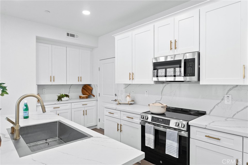 1993 Lyon Avenue Riverside, CA 92503 - Photo 15 of 61 a kitchen with cabinets appliances a sink and a counter top