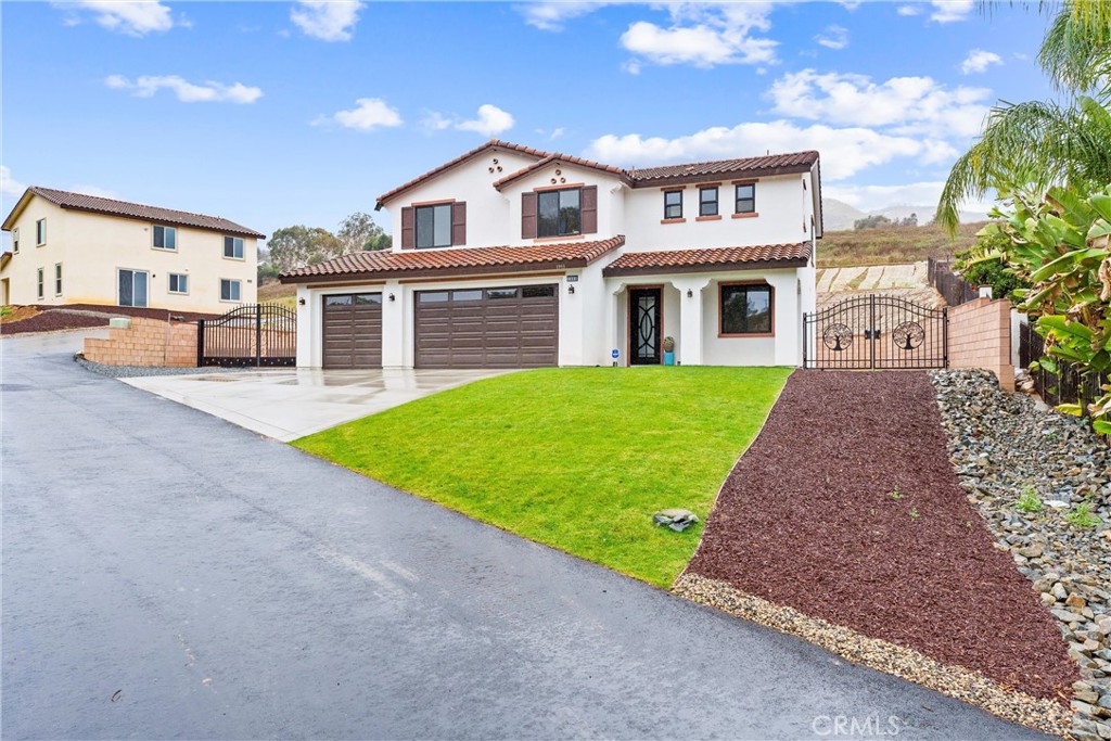 1993 Lyon Avenue Riverside, CA 92503 - Photo 3 of 61 a front view of a house with a yard and garage