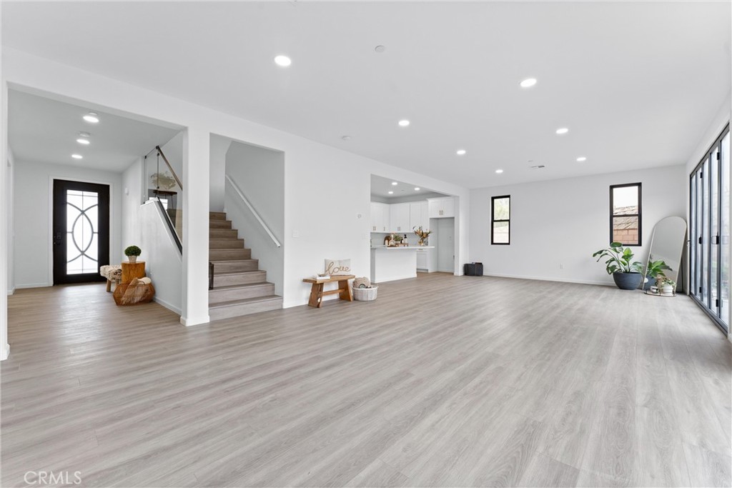 1993 Lyon Avenue Riverside, CA 92503 - Photo 7 of 61 a view of an empty room with wooden floor and stairs