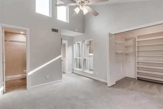 a view of walk in closet with empty racks