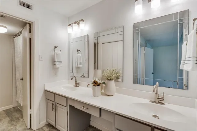 a view of an empty room with chandelier fan and stairs