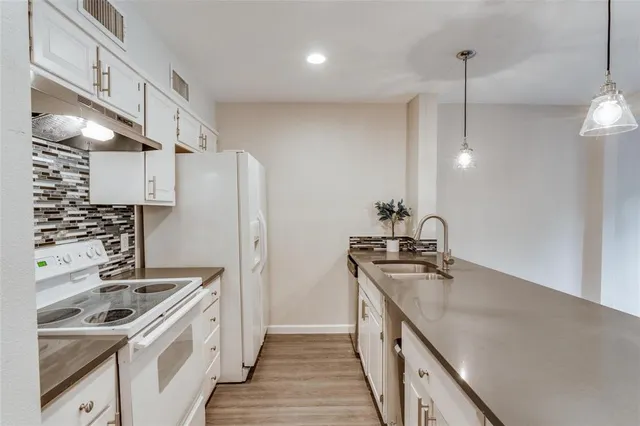 a kitchen with a sink a stove and refrigerator