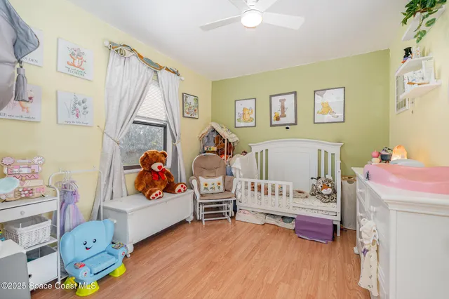 a bed room with furniture and a baby crib