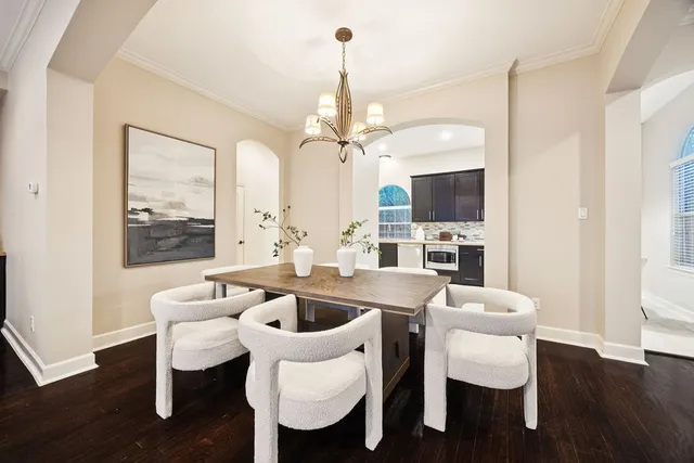 a view of a dining room with furniture wooden floor and chandelier
