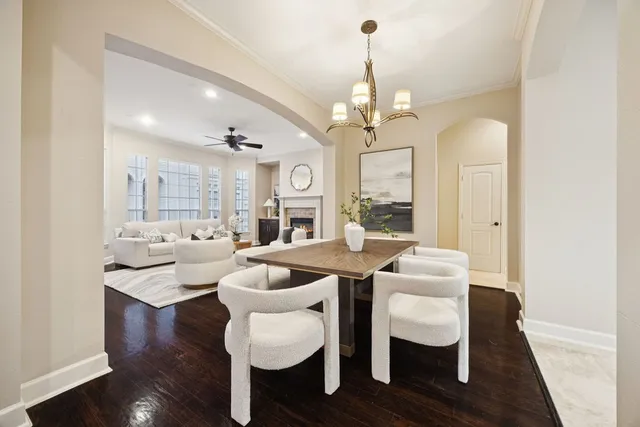 a view of a dining room with furniture wooden floor and chandelier