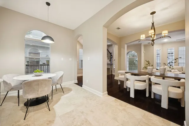 a room with lots of white furniture a window and appliances