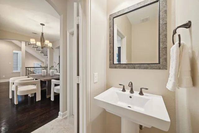 a bathroom with a sink a mirror and a vanity