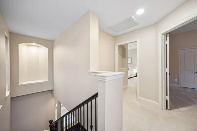 a view of a hallway with windows and entryway