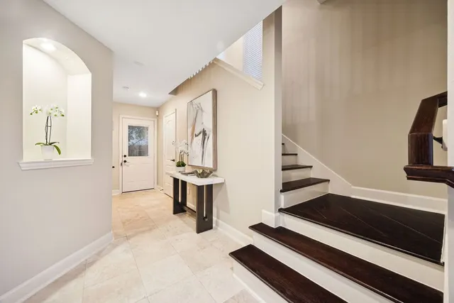 a view of a livingroom with furniture and staircase