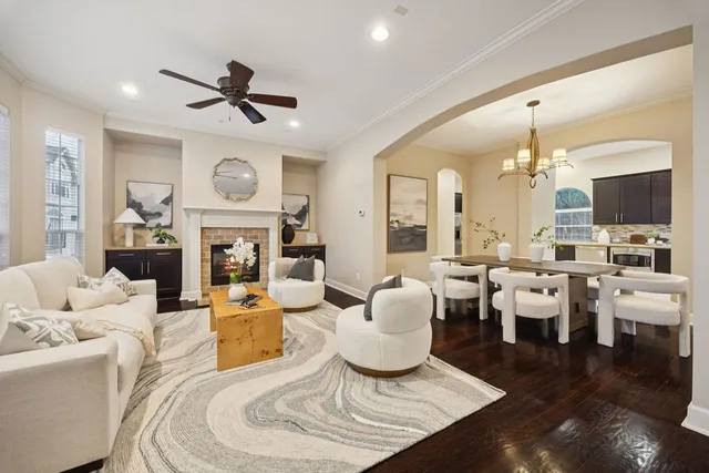 a living room with fireplace furniture and a large window
