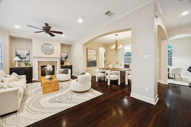 a view of a dining room with furniture a chandelier and wooden floor