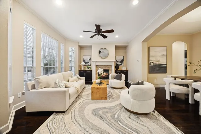 a living room with fireplace furniture and a large window