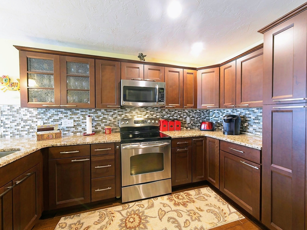 700 Shore Drive, Unit 1205 Fall River, MA 02721 - Photo 13 of 20 a kitchen with stainless steel appliances granite countertop a sink stove and refrigerator