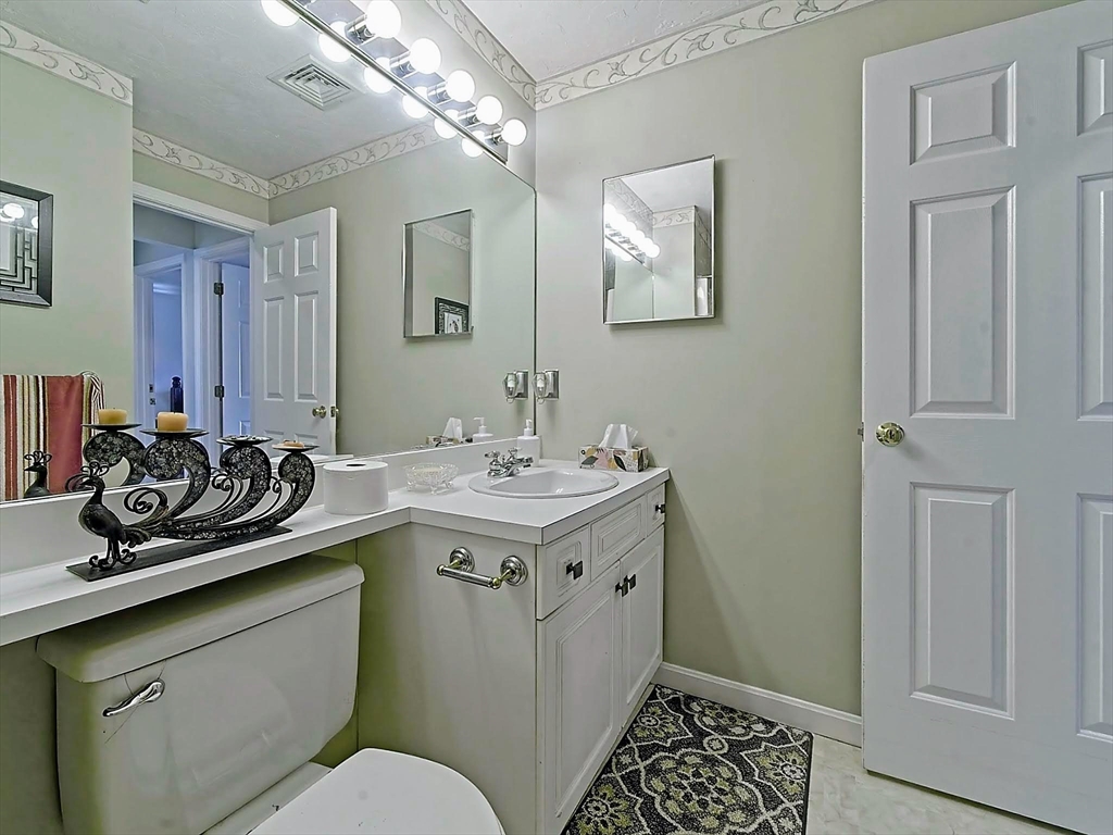 700 Shore Drive, Unit 1205 Fall River, MA 02721 - Photo 19 of 20 a bathroom with a sink a toilet and mirror