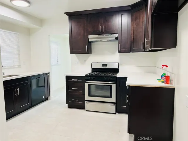 a kitchen with stainless steel appliances a stove and a microwave