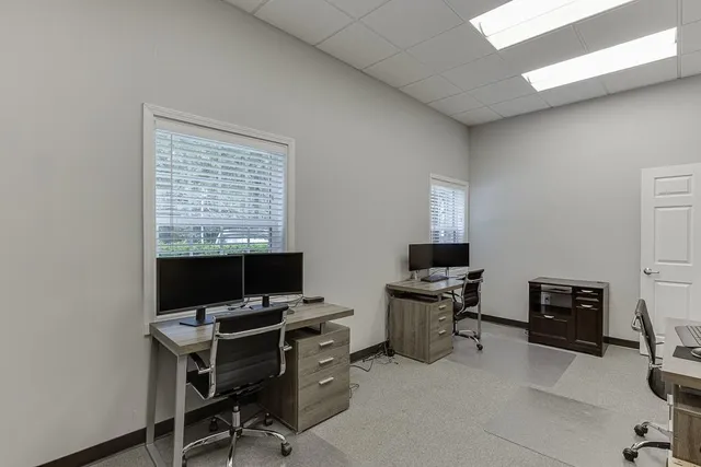 a room with a wooden floor and cabinets