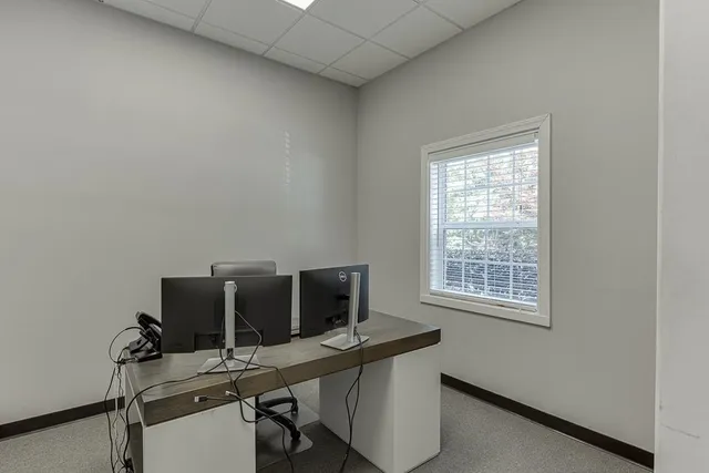 a view of a workspace with furniture