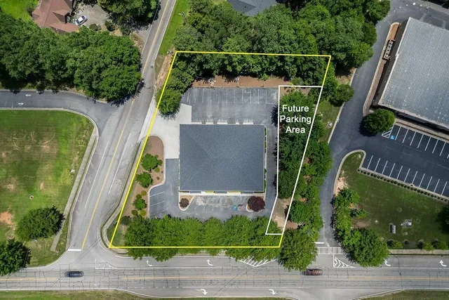 an aerial view of residential houses with outdoor space and river