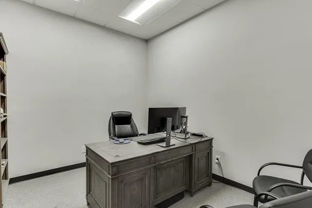 a work room with furniture and a window