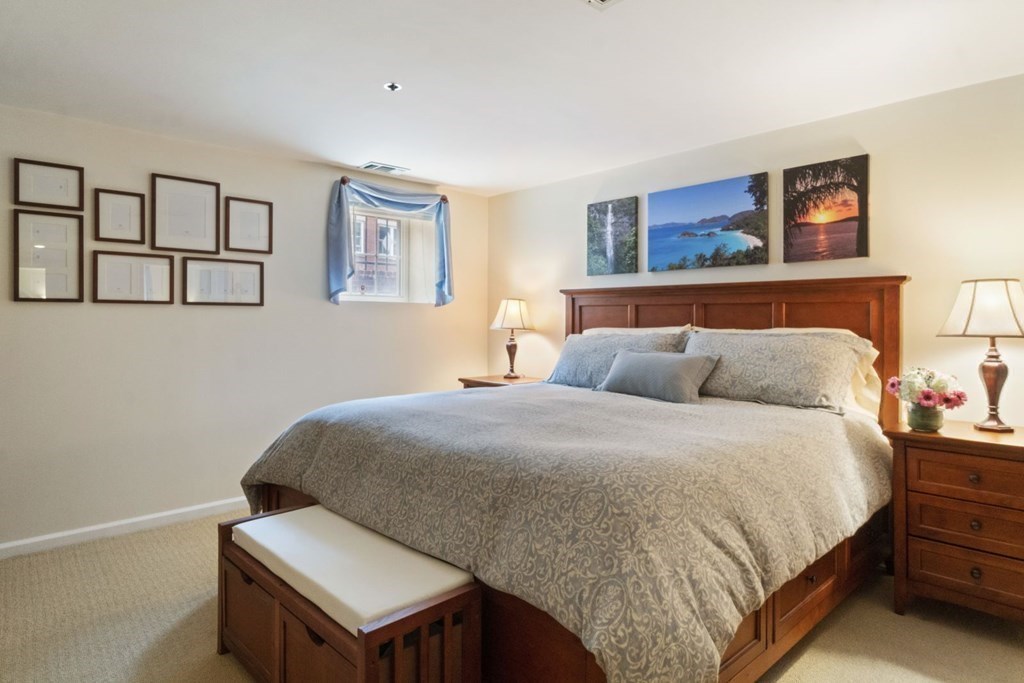 33 Main Street Boston, MA 02129 - Photo 11 of 17 a bed room with a bed and painting on the wall