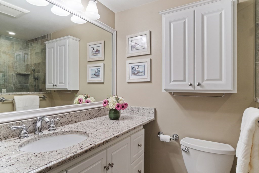 33 Main Street Boston, MA 02129 - Photo 13 of 17 a bathroom with a granite countertop sink a toilet and a mirror