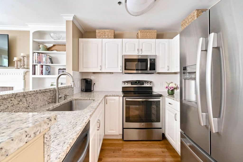 33 Main Street Boston, MA 02129 - Photo 5 of 17 a kitchen with granite countertop a refrigerator stove and microwave