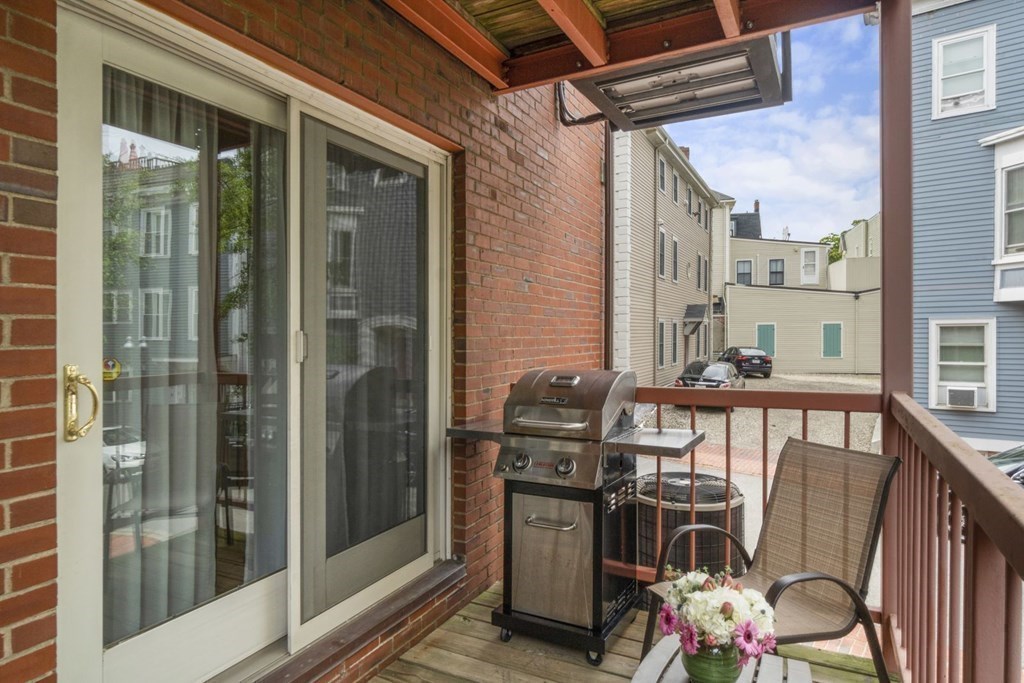 33 Main Street Boston, MA 02129 - Photo 7 of 17 a view of a balcony with chairs and a barbeque
