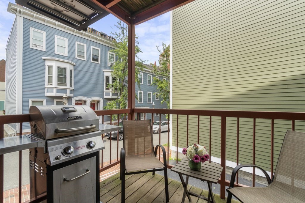 33 Main Street Boston, MA 02129 - Photo 8 of 17 a backyard of a house with barbeque oven table and chairs
