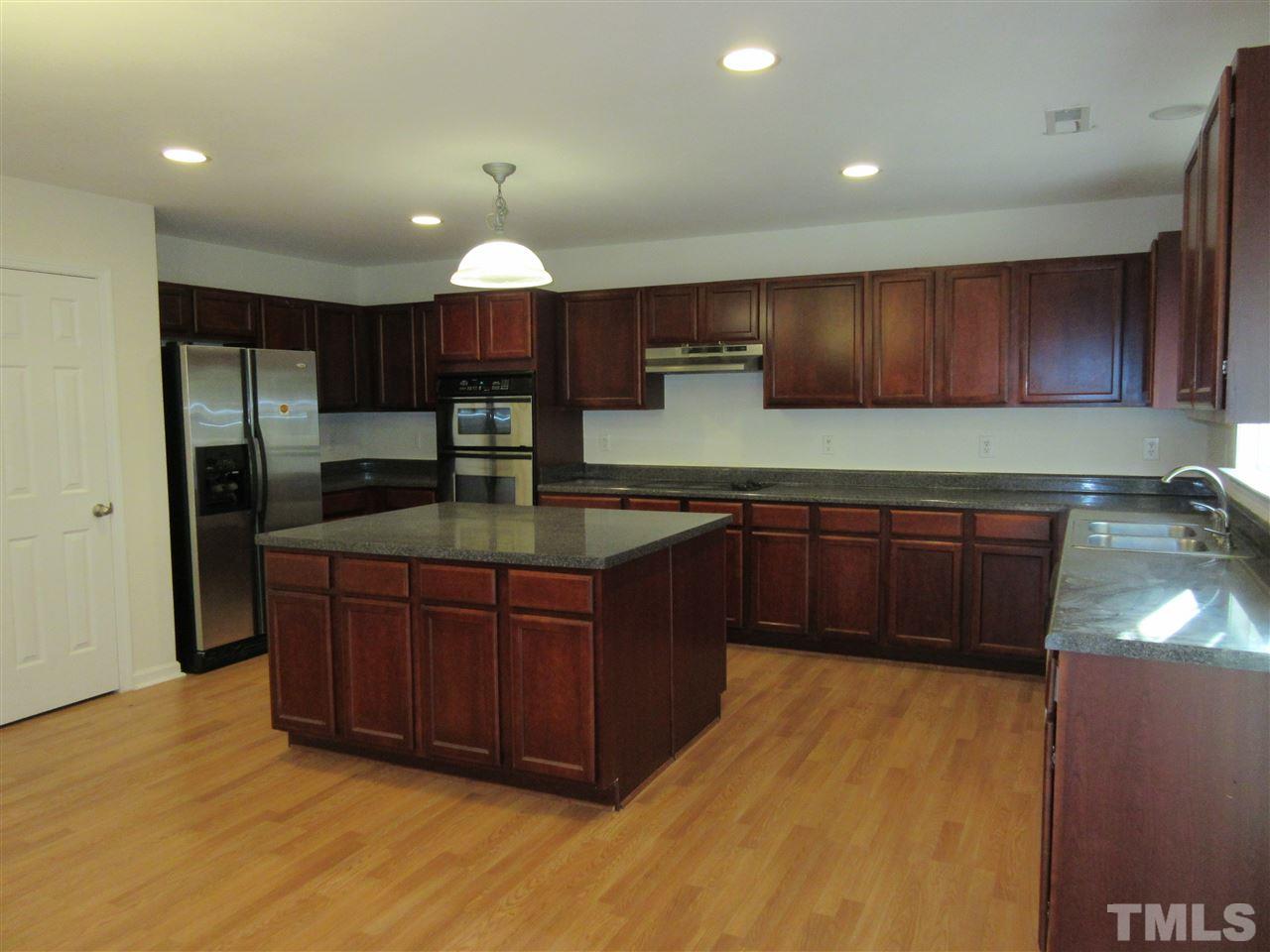 5253 Thornton Road Raleigh, NC 27616 - Photo 1 of 20 a kitchen with stainless steel appliances granite countertop wooden cabinets a sink and dishwasher