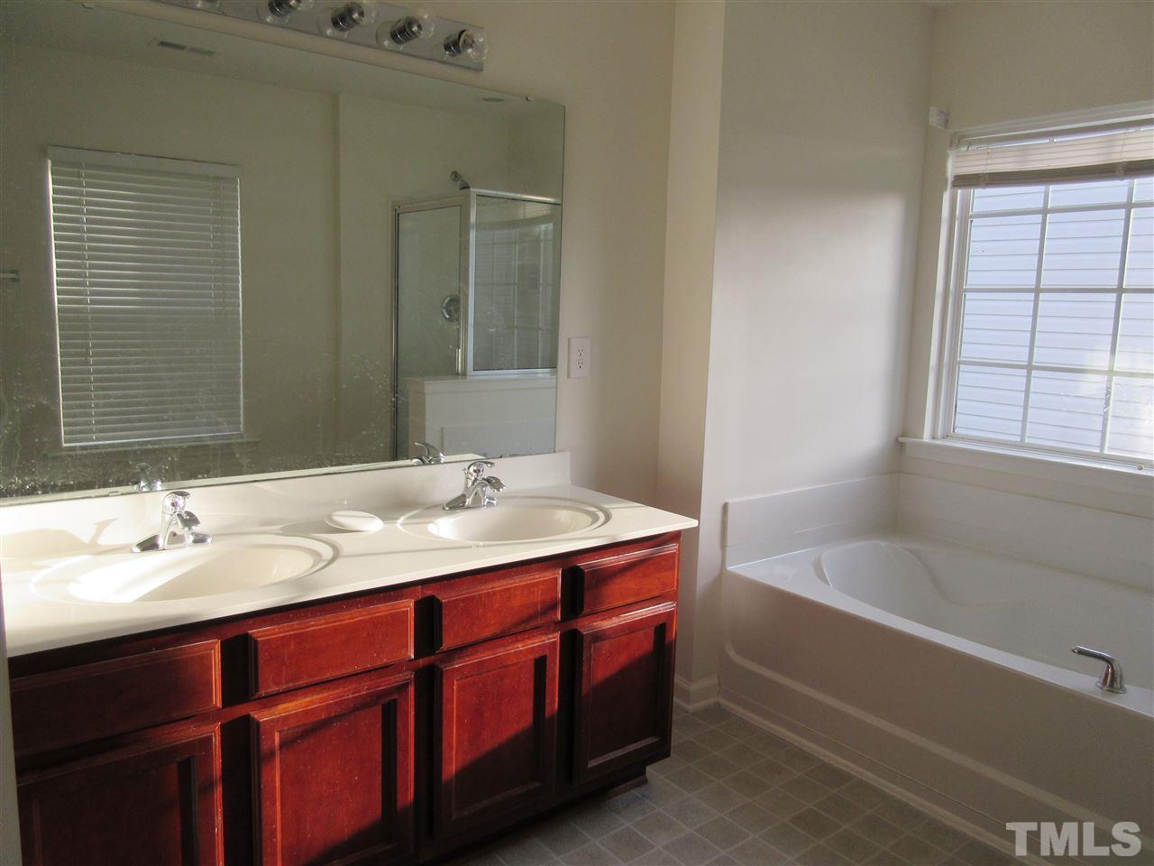 5253 Thornton Road Raleigh, NC 27616 - Photo 11 of 20 a bathroom with a tub sink and mirror
