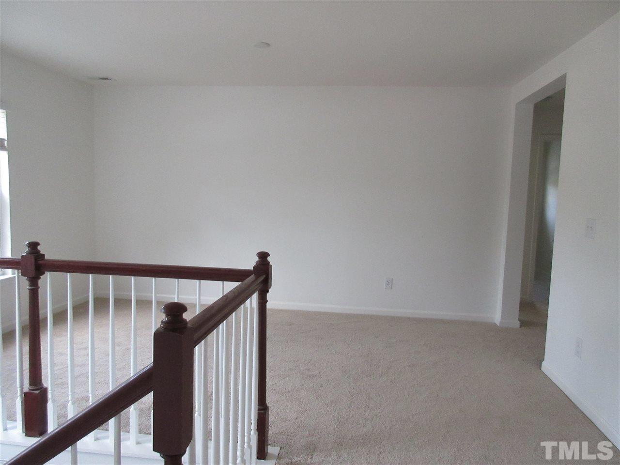 5253 Thornton Road Raleigh, NC 27616 - Photo 15 of 20 a view of staircase with wooden floor and white walls