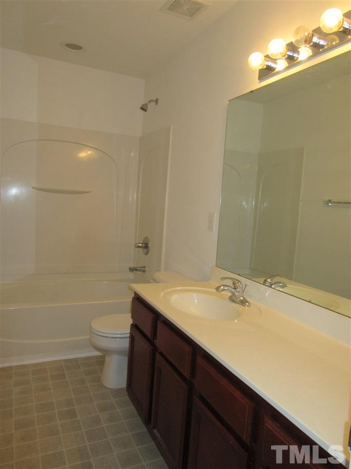 5253 Thornton Road Raleigh, NC 27616 - Photo 17 of 20 a bathroom with a sink a toilet and shower