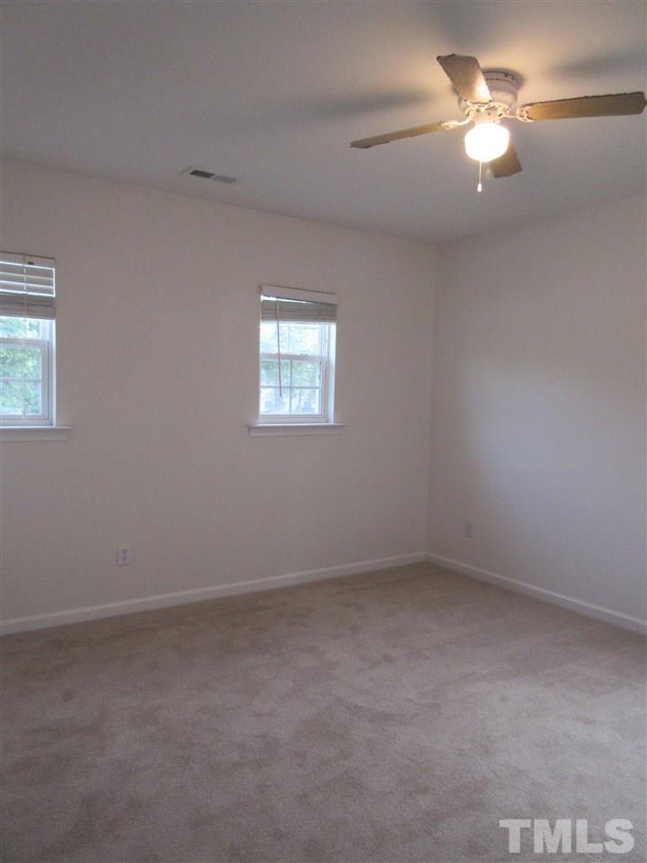 5253 Thornton Road Raleigh, NC 27616 - Photo 19 of 20 an empty room with chandelier fan and window