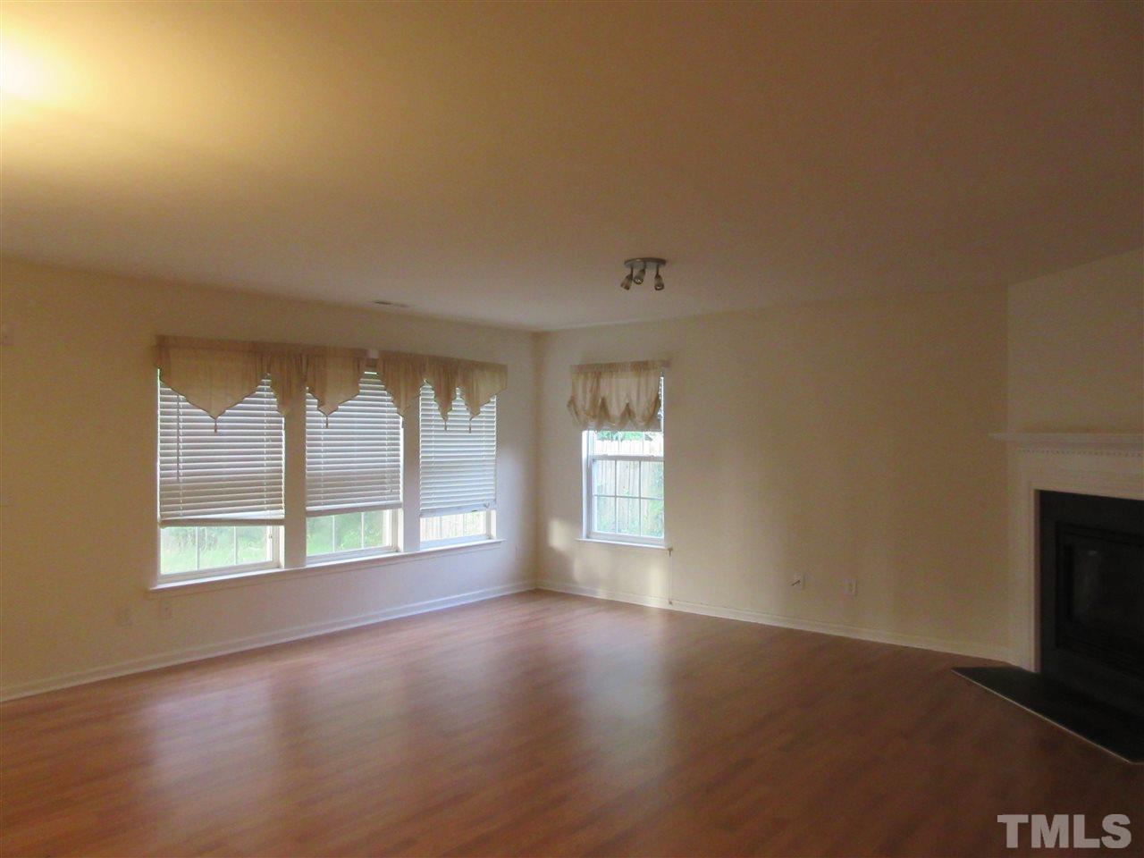 5253 Thornton Road Raleigh, NC 27616 - Photo 3 of 20 an empty room with wooden floor and windows