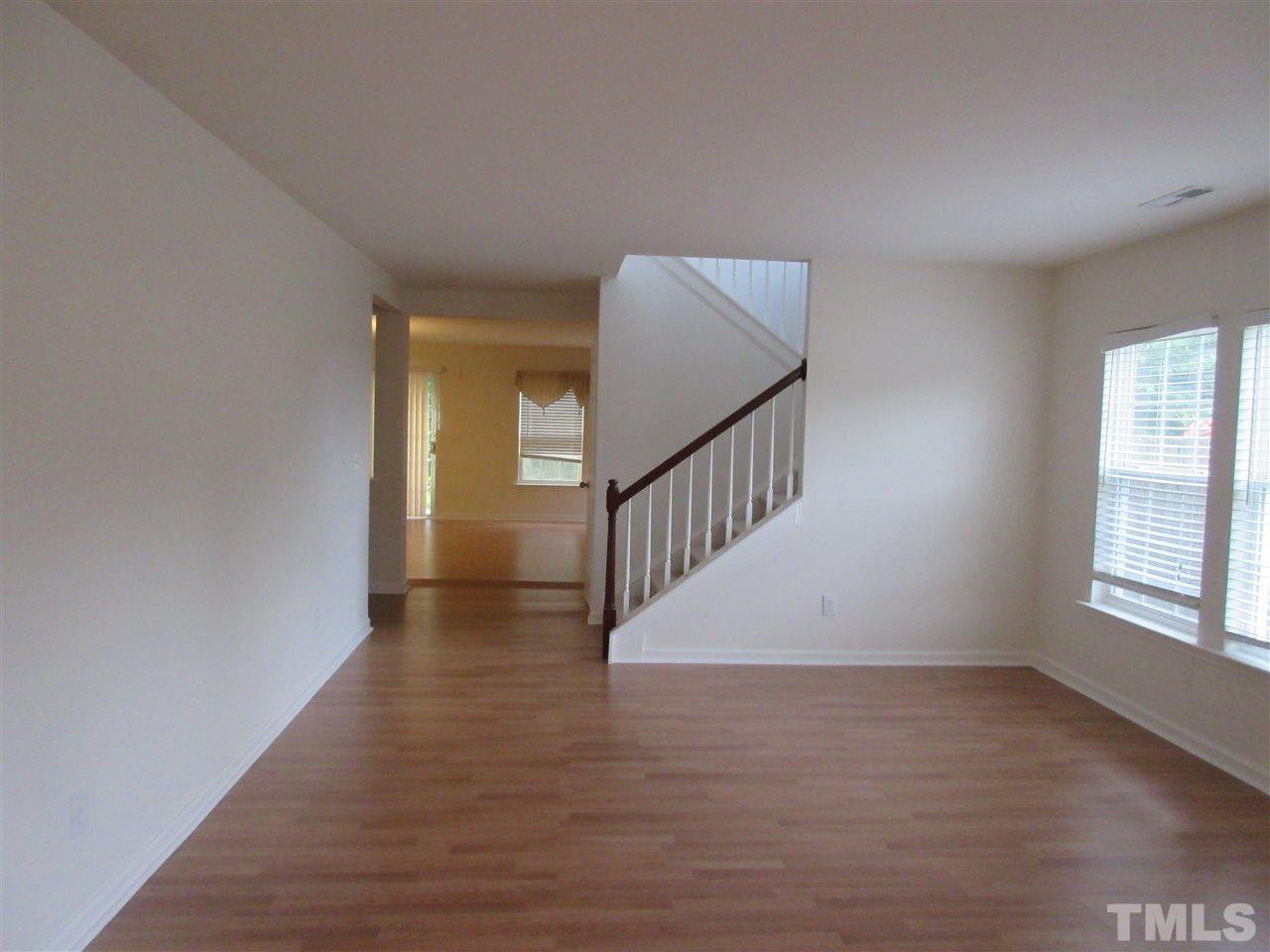 5253 Thornton Road Raleigh, NC 27616 - Photo 4 of 20 a view of an empty room with wooden floor and a window