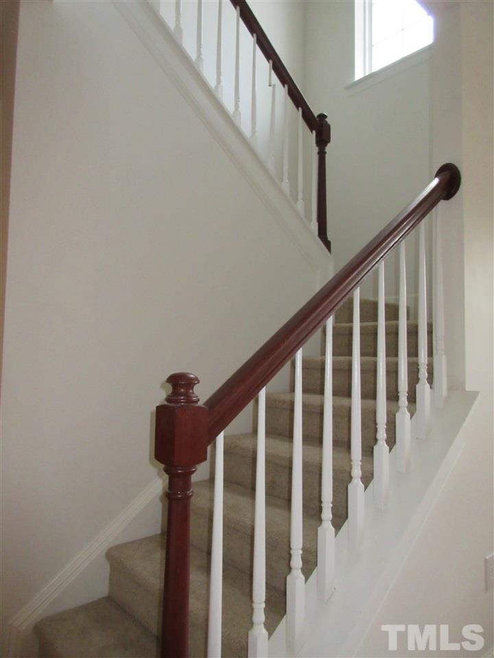 5253 Thornton Road Raleigh, NC 27616 - Photo 5 of 20 a view of staircase with railing and white walls