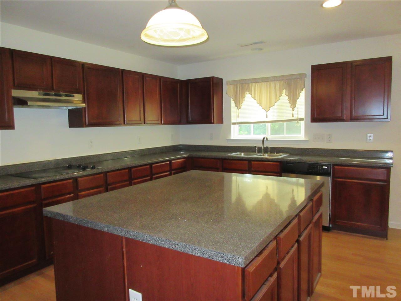 5253 Thornton Road Raleigh, NC 27616 - Photo 7 of 20 a kitchen with a sink a window and cabinets