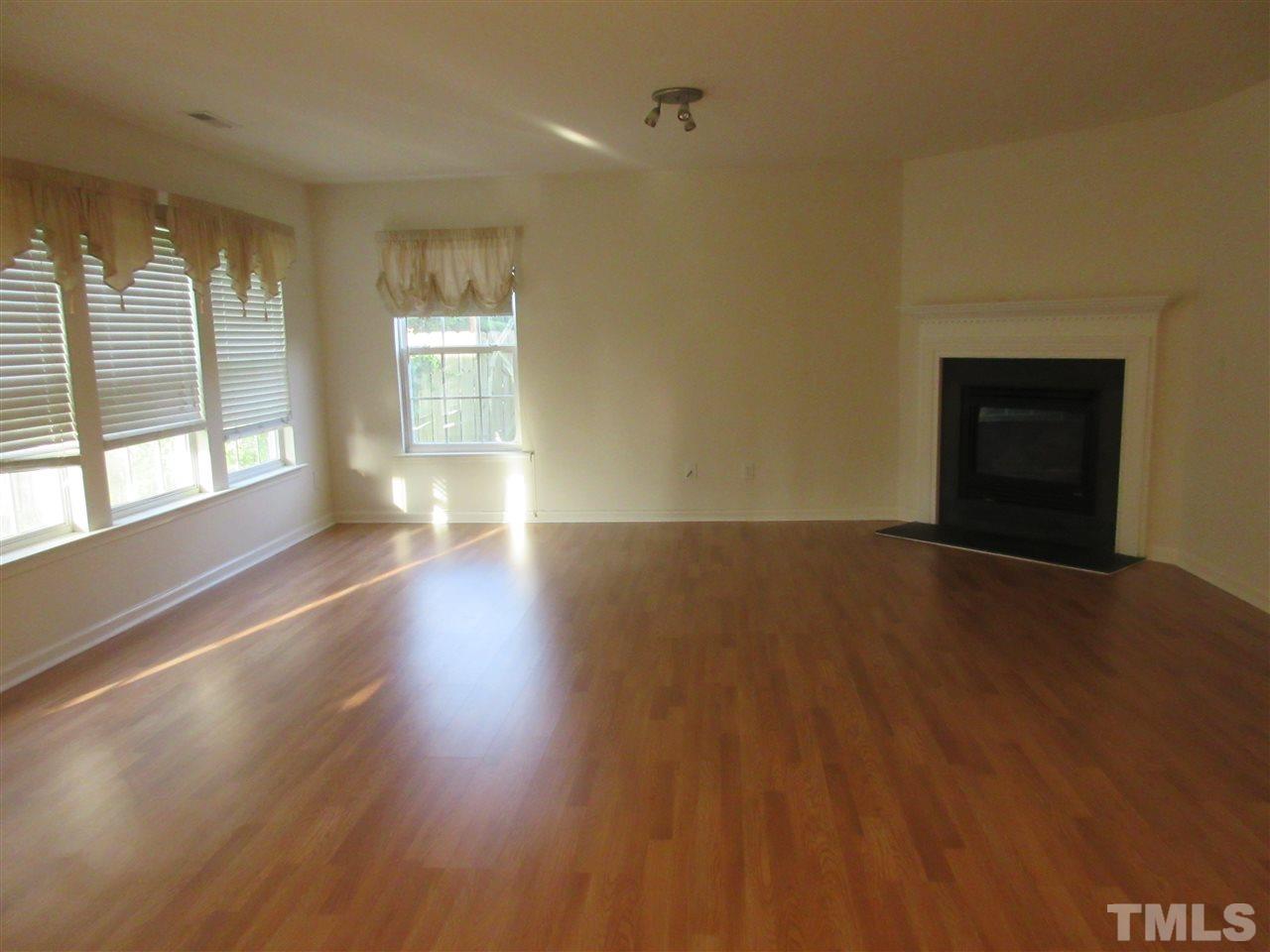 5253 Thornton Road Raleigh, NC 27616 - Photo 8 of 20 an empty room with wooden floor and windows