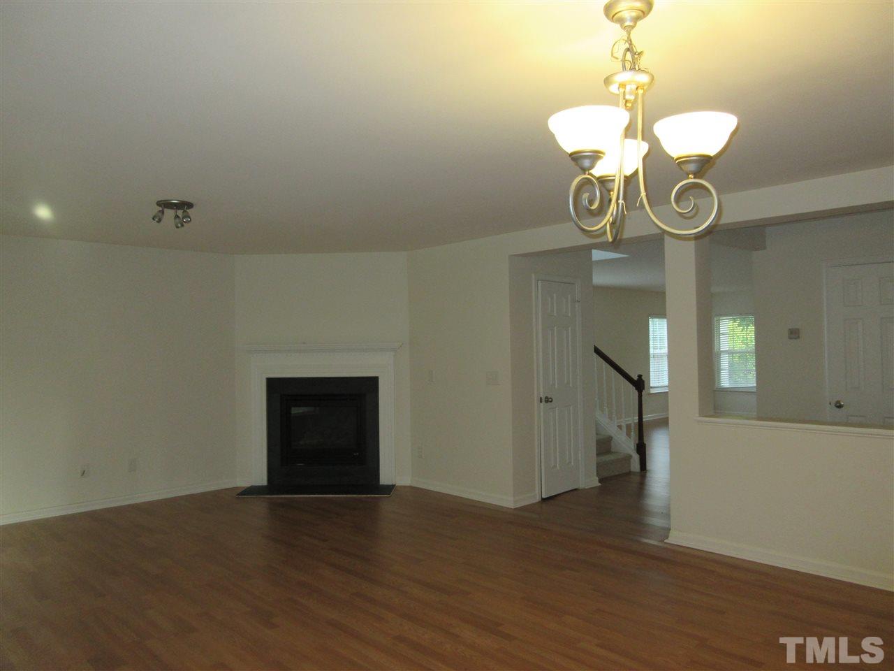 5253 Thornton Road Raleigh, NC 27616 - Photo 9 of 20 a view of a room with wooden floor and chandelier
