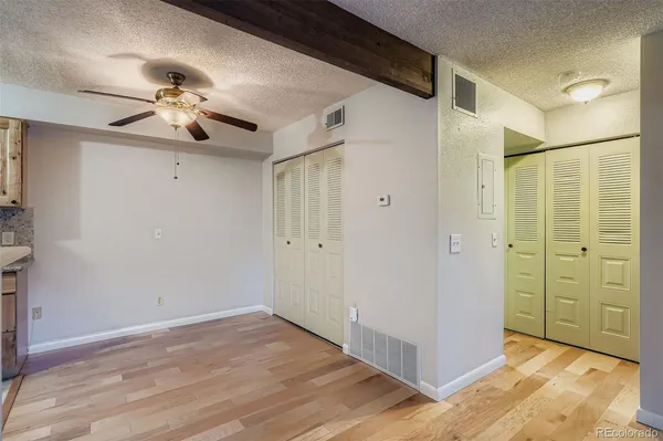 a view of a livingroom with a ceiling fan and entryway