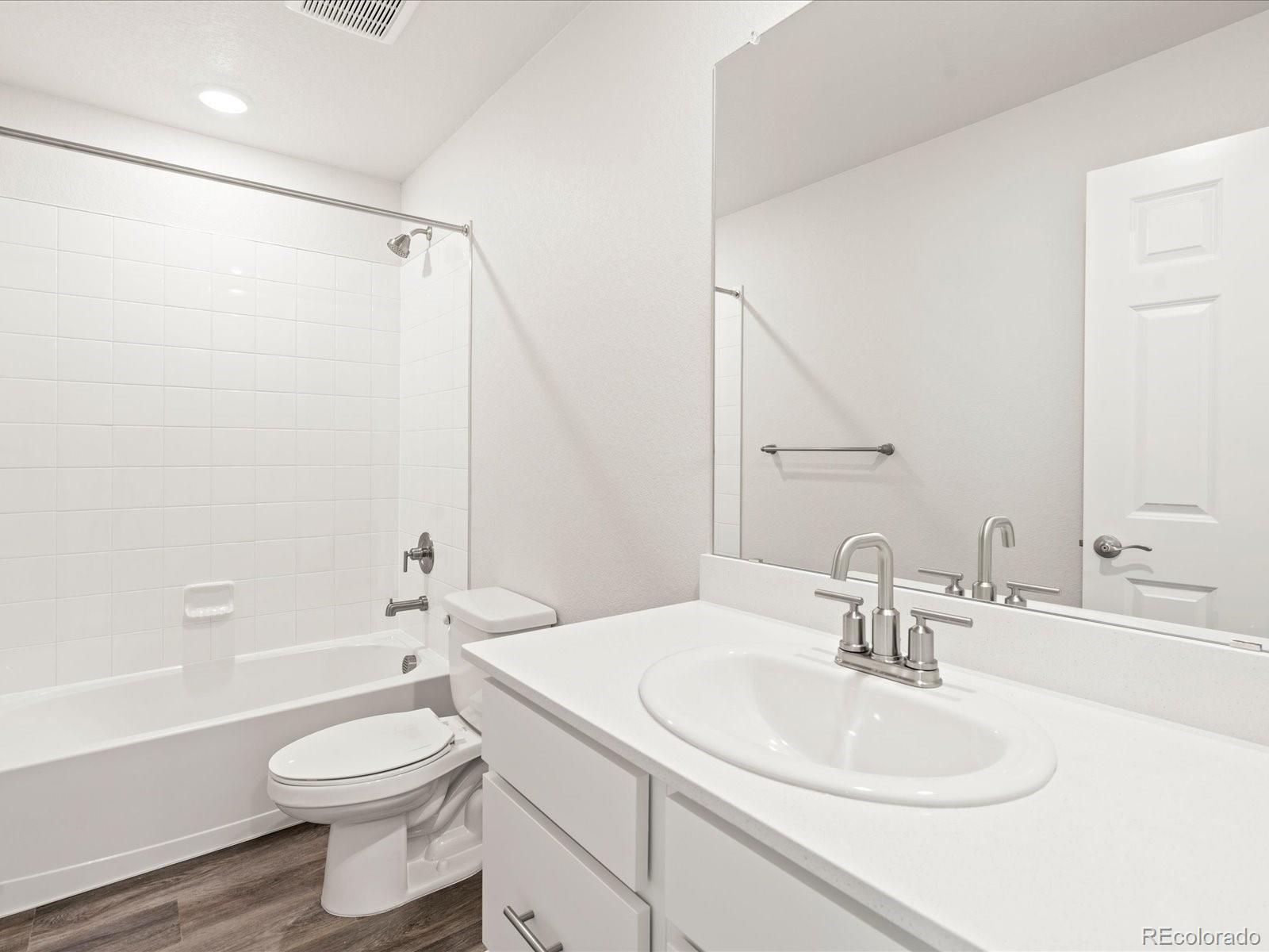 14422 Pansy Loop Morrison, CO 80465 - Photo 14 of 33 a bathroom with a sink toilet and shower