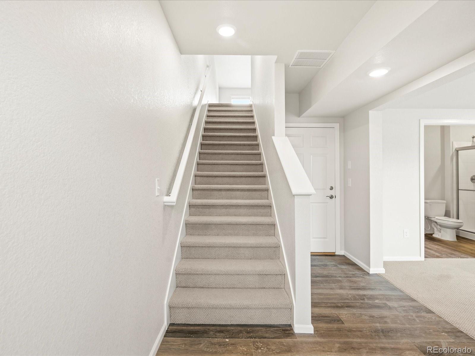 14422 Pansy Loop Morrison, CO 80465 - Photo 3 of 33 a view of entryway and hall with wooden floor