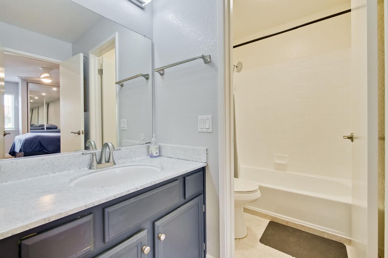 363 Kenbrook Circle San Jose, CA 95111 - Photo 13 of 21 a bathroom with a granite countertop sink a toilet and shower