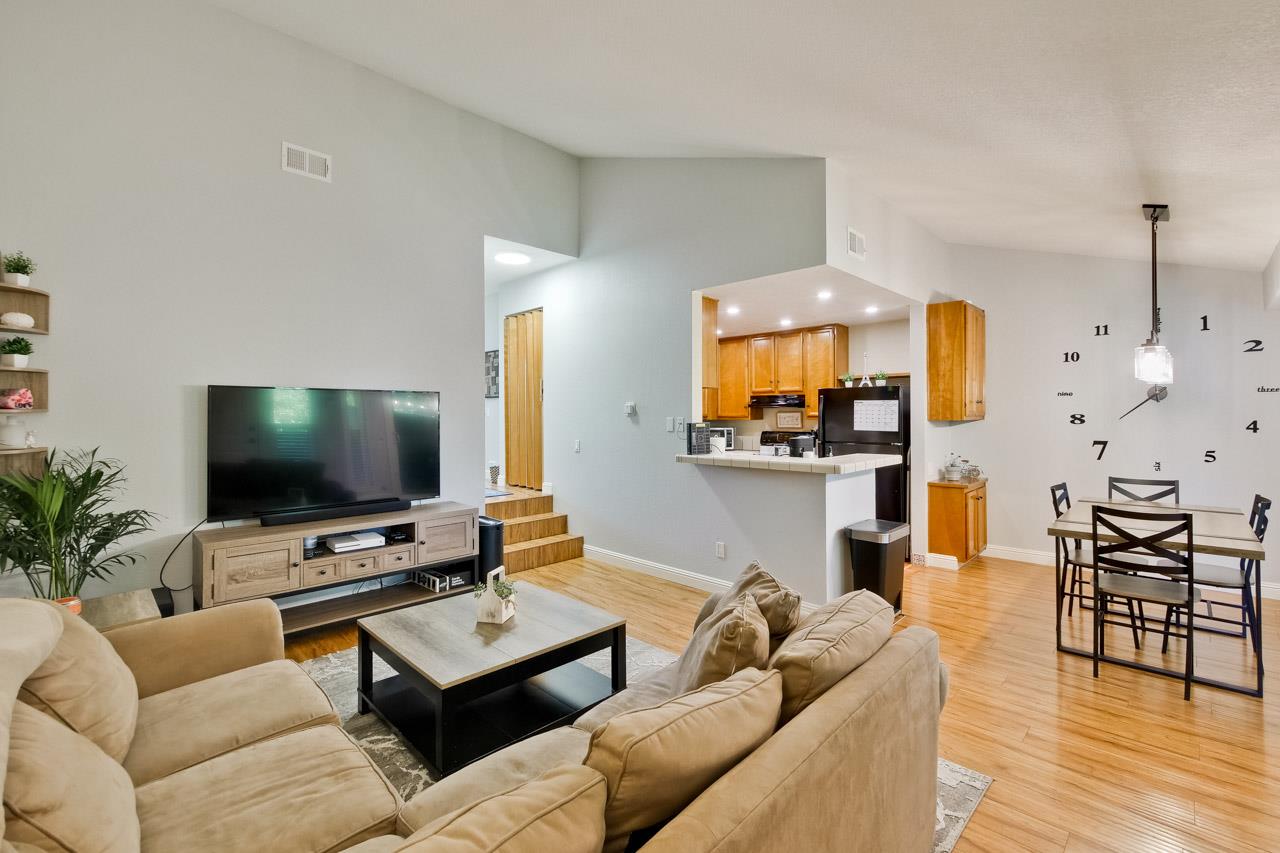 363 Kenbrook Circle San Jose, CA 95111 - Photo 3 of 21 a living room with furniture and a flat screen tv with wooden floor