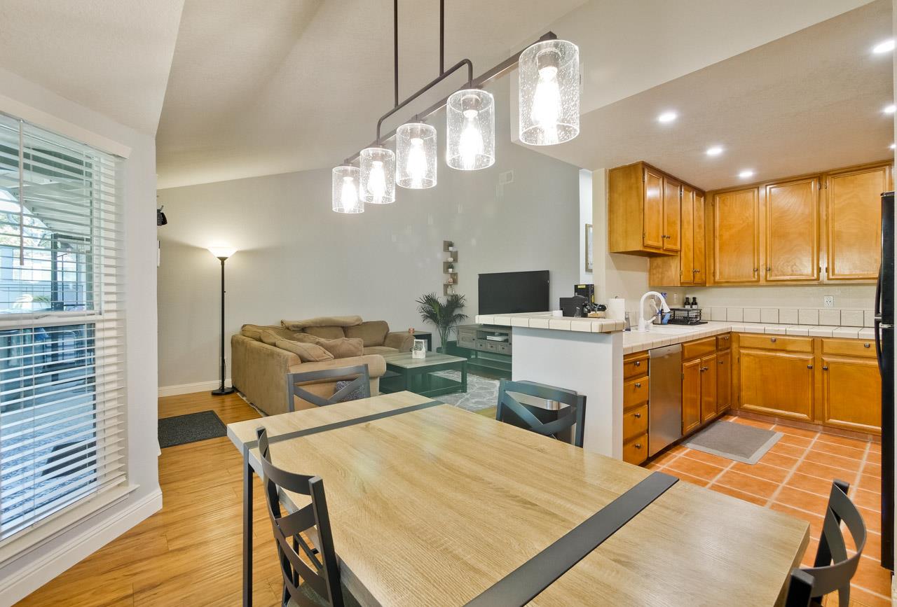 363 Kenbrook Circle San Jose, CA 95111 - Photo 10 of 21 a kitchen that has a lot of cabinets in it and wooden floors