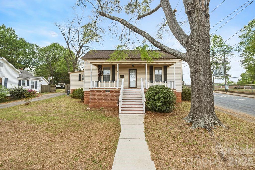 a front view of a house with a yard garage and outdoor seating