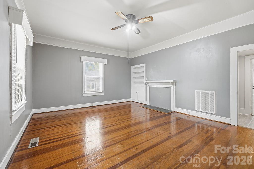 625 North Main Street Kannapolis, NC 28081 - Photo 12 of 26 a view of empty room with wooden floor and fan