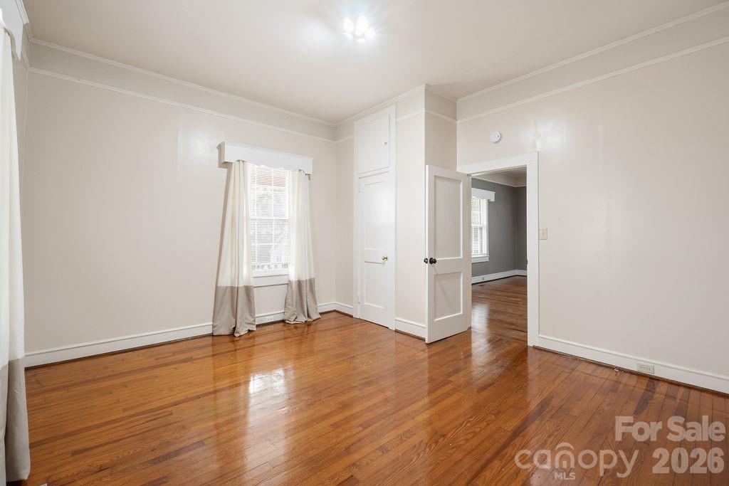 625 North Main Street Kannapolis, NC 28081 - Photo 16 of 26 an empty room with wooden floor and windows