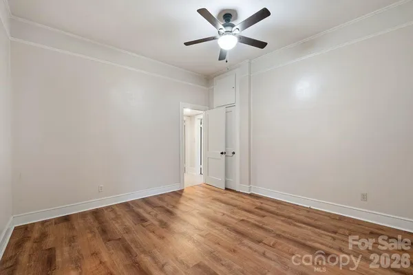 a view of an empty room with wooden floor