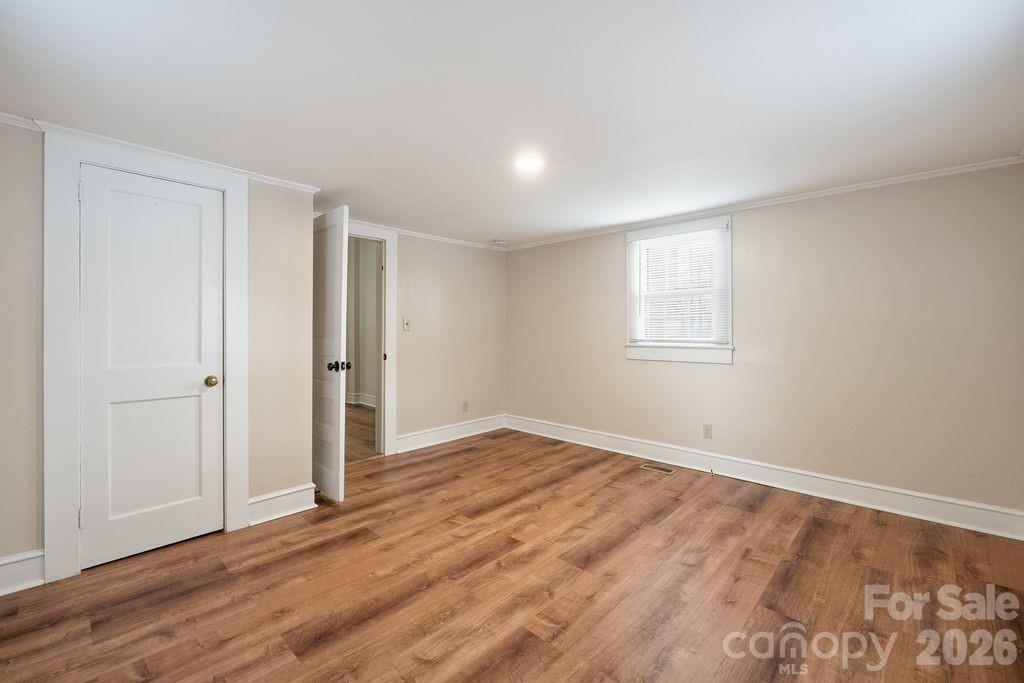 625 North Main Street Kannapolis, NC 28081 - Photo 20 of 26 a view of an empty room with wooden floor and a window